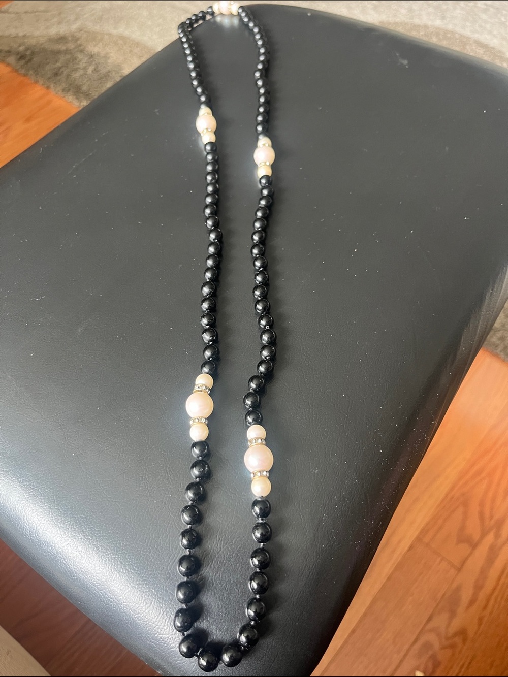 Elegant Black Bead Necklace with Pink Pearls and Gold Accents